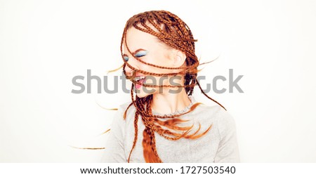 Girl with dreadlocks, pigtails dancing, model in the style of the 80s. 90s, with bright blue make-up. DJ girl on a white background posing. Drive photo of the model in the old style.