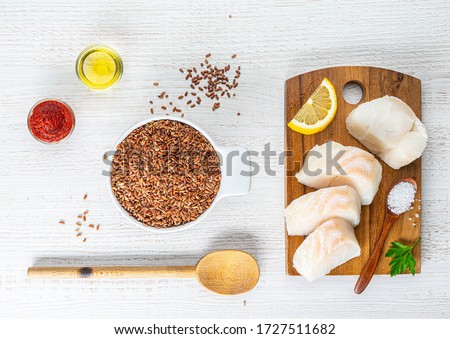 chopped cod on a wooden board on white