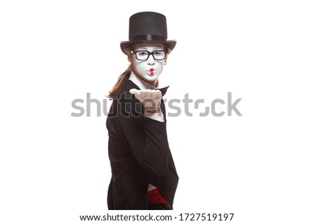 Portrait of male mime artist performing, isolated on white background. Mime blows a kiss. Symbol of sympathy, love, relationships