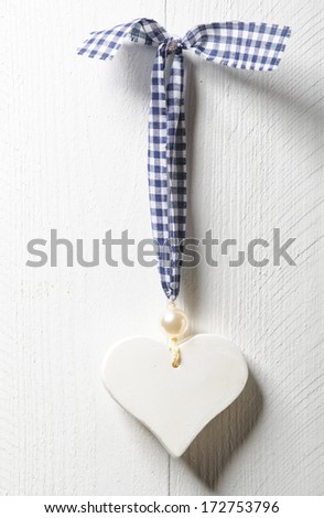 Love heart hanging on wooden texture background, valentines day card concept