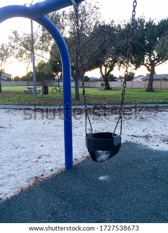 Empty swing at playground for baby and toddler saftey seat
