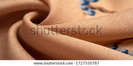 Texture, background, pattern, Crepe de Chin. Beige color, blue flowers. This is a group of silk, characterized by roughness, as well as slightly wrinkled.