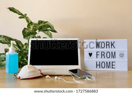 Telecommuting job from home. Photography of a laptop whit black screen. Mockup. With a notebook and a lightbox in the desktop and a cellphone.