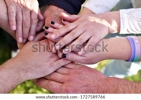 Hands close-up of people of various ages symbolising the concept of family, love and different generations of society working together as a team. Royalty-Free Stock Photo #1727589766