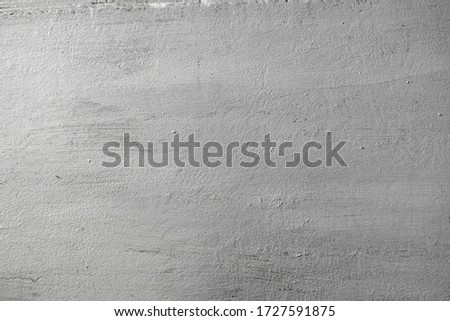 Concrete texture of wall painted in silver color with rough surface. Abstract background.