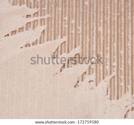Torn corrugated fiberboard