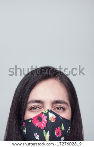 Woman portrait in serious mood with face mask, physycal distancing mood.