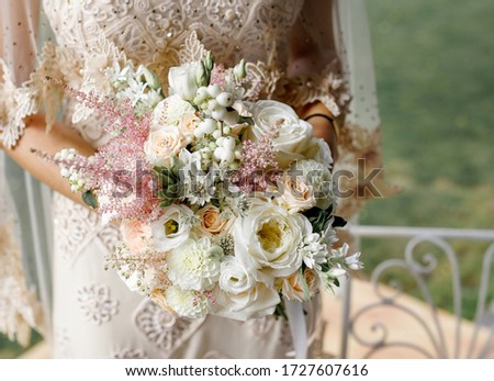 Bride holding pastel colors wedding bouquet in your hands, horizontal 