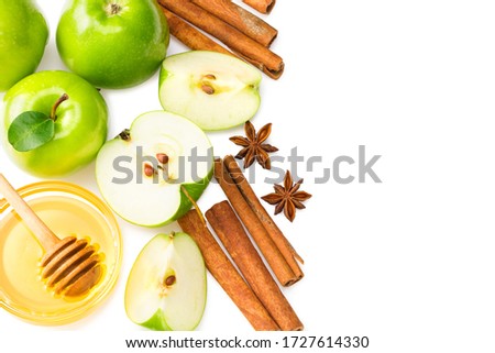 green apples with slices, green leaves, cinnamon, honey and star anise isolated on white background. top view