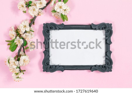 Photo frame with white frame mockup. Floral pattern on a pink background
