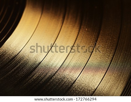 Segment of vinyl record with label showing the texture of the grooves, retro look 