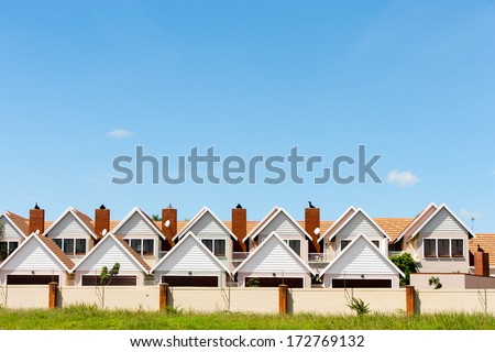 Residential fenced house complex against blue sky. Royalty-Free Stock Photo #172769132