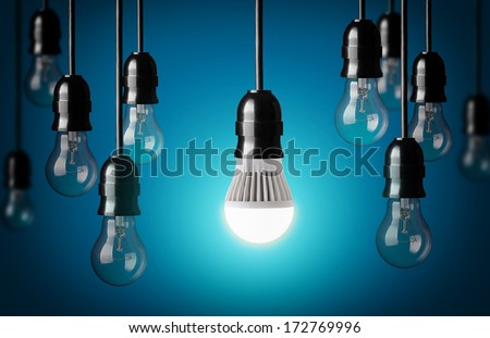 LED bulb and simple light bulbs.Blue background  Royalty-Free Stock Photo #172769996