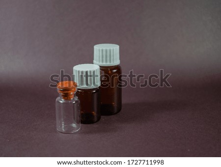 small glass bottles of different colors and shapes