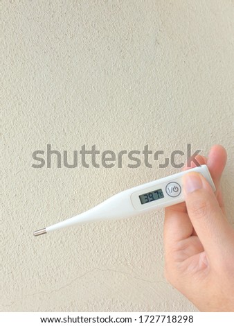 Electronic thermometer close up on woman hand.