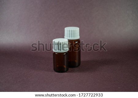 small brown bottle with white cap