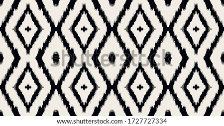 Ikat geometric folklore ornament with diamonds. Tribal ethnic vector texture. Seamless striped pattern in Aztec style. Folk embroidery. Indian, Scandinavian, Gypsy, Mexican, African rug. Royalty-Free Stock Photo #1727727334