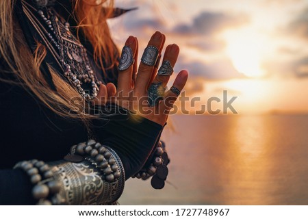 close up of woman hands. tribal style woman on the beach at sunset Royalty-Free Stock Photo #1727748967