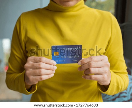 Female hand holding a credit card. Online shopping concept.