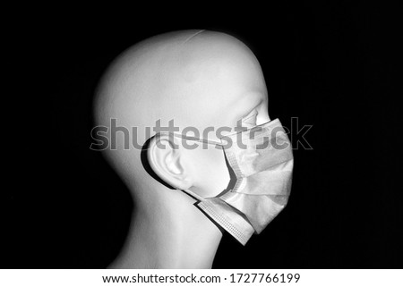 A mannequin dummy wears a virus mask