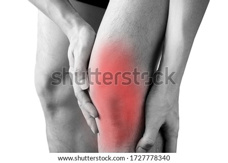 Black and white picture .Knee pain .man stand hand caught at the knee.  health concepts