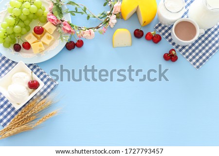 Top view photo of dairy products over pastel blue background. Symbols of jewish holiday - Shavuot Royalty-Free Stock Photo #1727793457