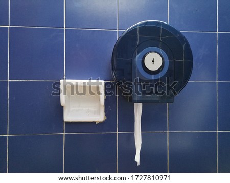 Tissue paper box placed at blue brickwall in the toilet