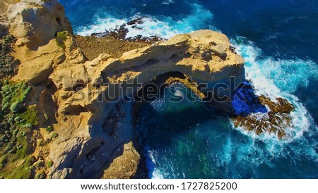 The Arch rock formation along the Great Ocean Road, Victoria - Australia. Aerial view on a sunny morning.