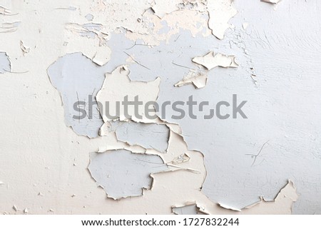 Texture of white flaking paint on grey surface. Background idea design, close-up, top view Royalty-Free Stock Photo #1727832244