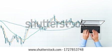 Stock market analysis. Candlestick chart and laptop. Top view of using laptop for trading. 
 Royalty-Free Stock Photo #1727853748