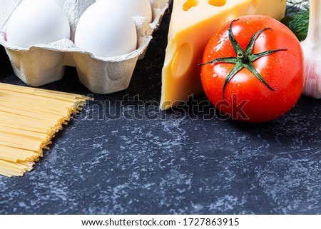 Dietary balance picture with fruits and vegetables on black stone background