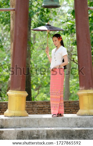 Portail of beautiful woman with traditional northern thai dress in temple