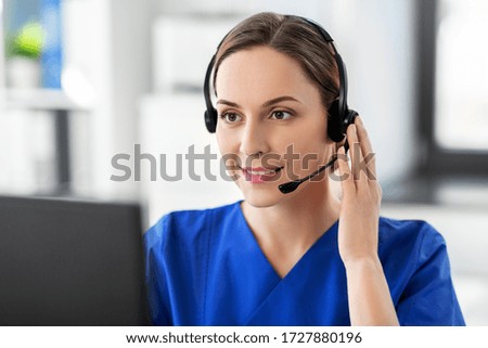 medicine, technology and healthcare concept - happy smiling female doctor or nurse with headset and computer working at hospital Royalty-Free Stock Photo #1727880196