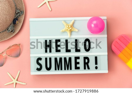 Table top view accessory of clothing women plan to travel in Hello text summer holiday background concept.Ice cream with many essential item hat & sunglasses, starfish,ball on pink paper.greeting card