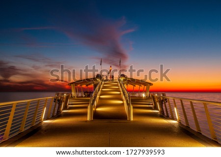 The pier of Lido di Camaiore, Tuscany, Italy, is a famous landmark of the coast of Versilia.  Royalty-Free Stock Photo #1727939593