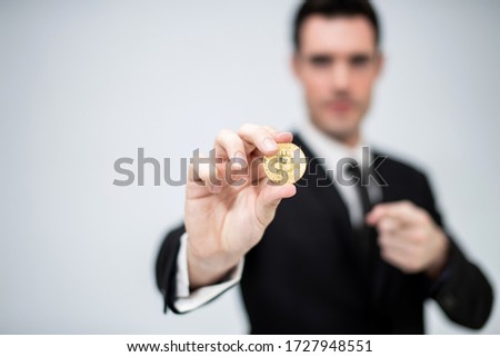caucasian businessman holding and show golden bit coin with copy space 