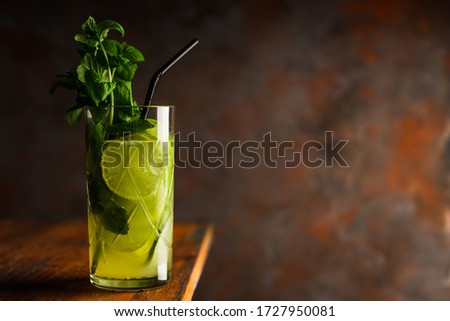 Mojito cocktail with lime and mint on the rustic background. Selective focus. Shallow depth of field.