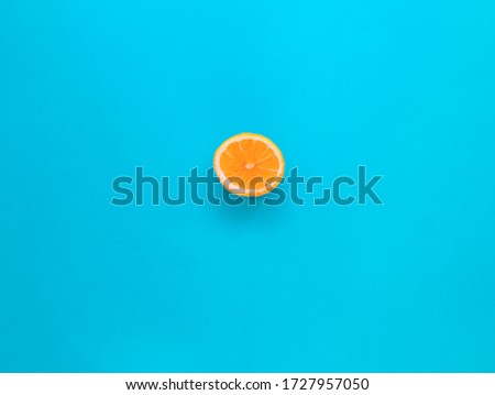 Flat lay top view of fresh sliced a half of lemon over pastel blue backdrop with minimal style, copy space