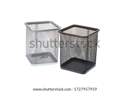 Black and gray metal mesh desk organizers for pens, isolated on white background