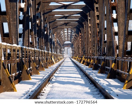 Italy, railway bridge in the Po valley in winter with snow