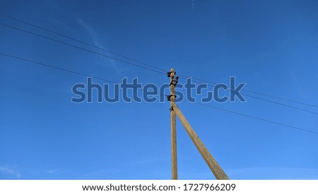 electronic pole with wires against the sky
