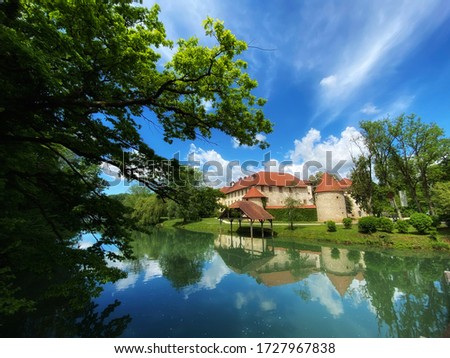Otocec castle, a medieval castle in Slovenia, lake Krka in a sunny spring day
