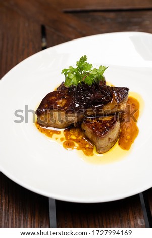 Grilled Foie gras, grilled duck and goose live poultry, with plum savory sauce. Gourmet internationl cuisine recipe using for buffet food and drink concept.