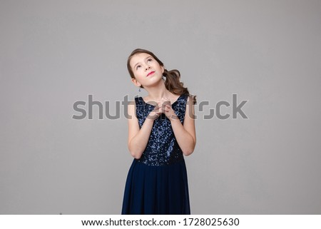 Handsome young girl hopes for a something good, picture isolated on white background