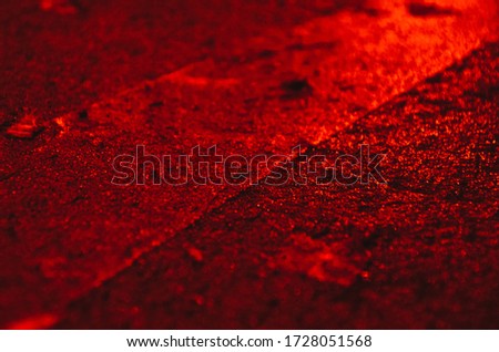 
texture road in red lighting with one white stripe