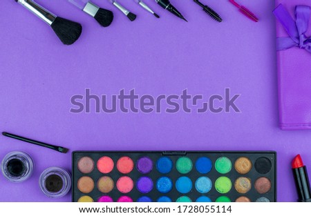 beauty flat lay. makeup tools on a purple background. frame.