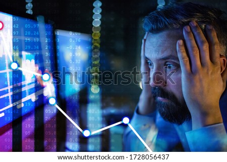 Frustrated businessman with computer sitting at desk, financial crisis and corona virus concept. Royalty-Free Stock Photo #1728056437