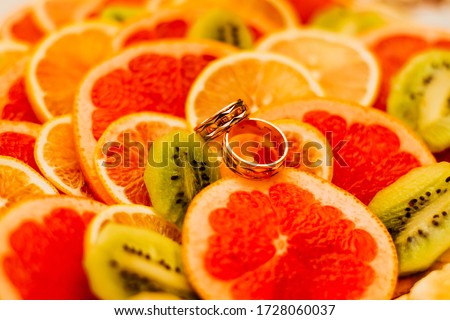 two wedding rings on oranges marriage orange