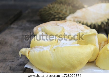Durian riped and fresh with yellow colour on wooden table.