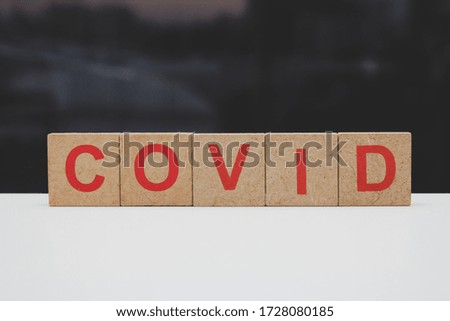 
covid written with wooden squares